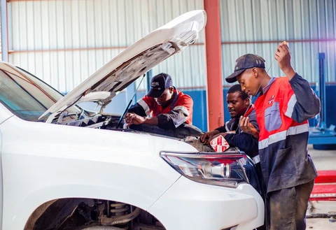 MECCA mechanics checking an engine